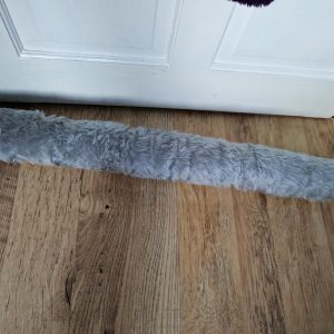 grey fluffy draught excluder